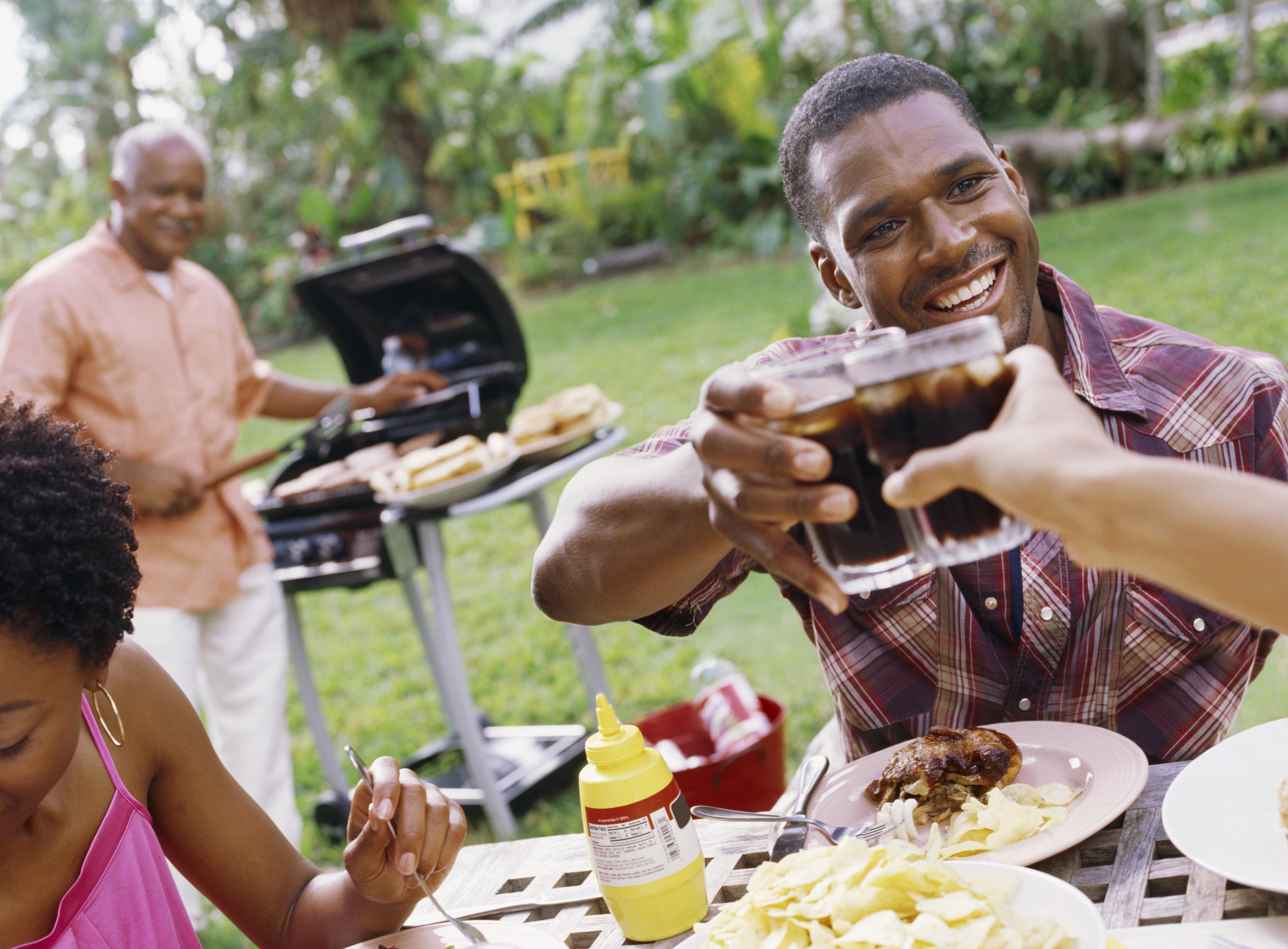men toasting at a outdoor barbeque
