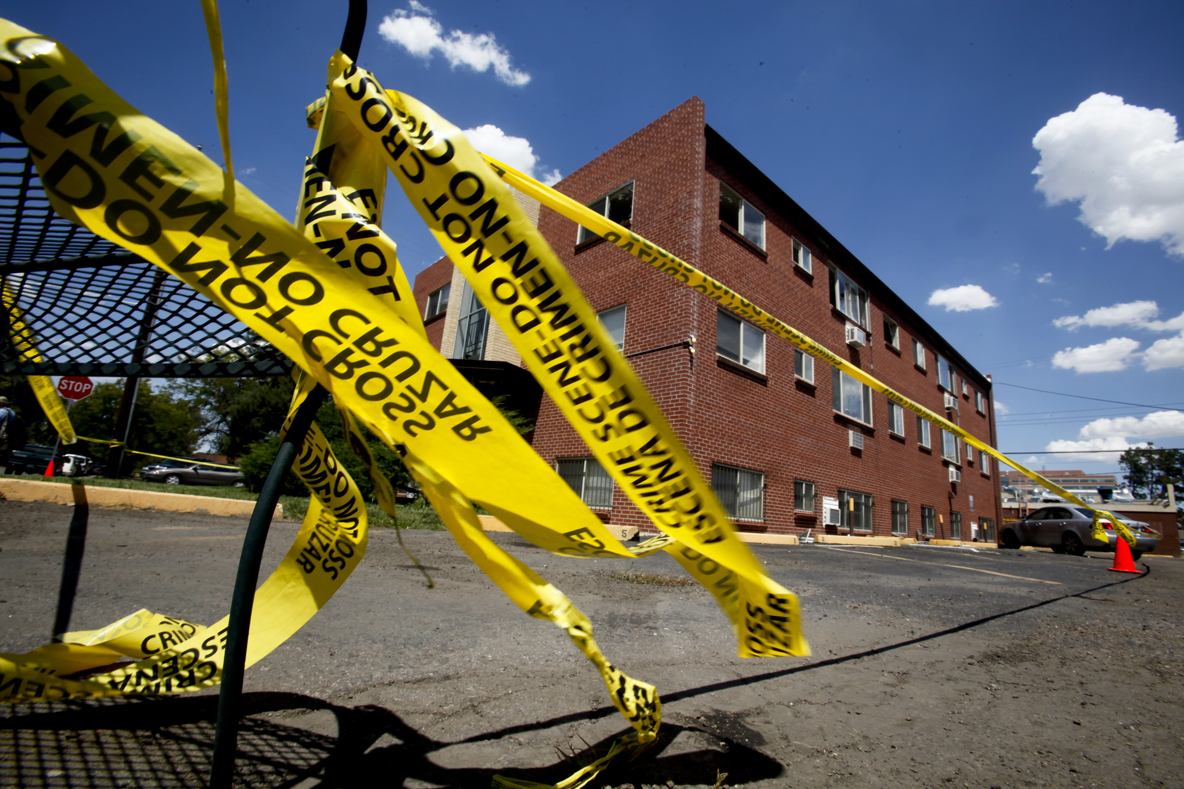 Police tape flutters in the breeze while prosecution teams continue to investigate the apartment co
