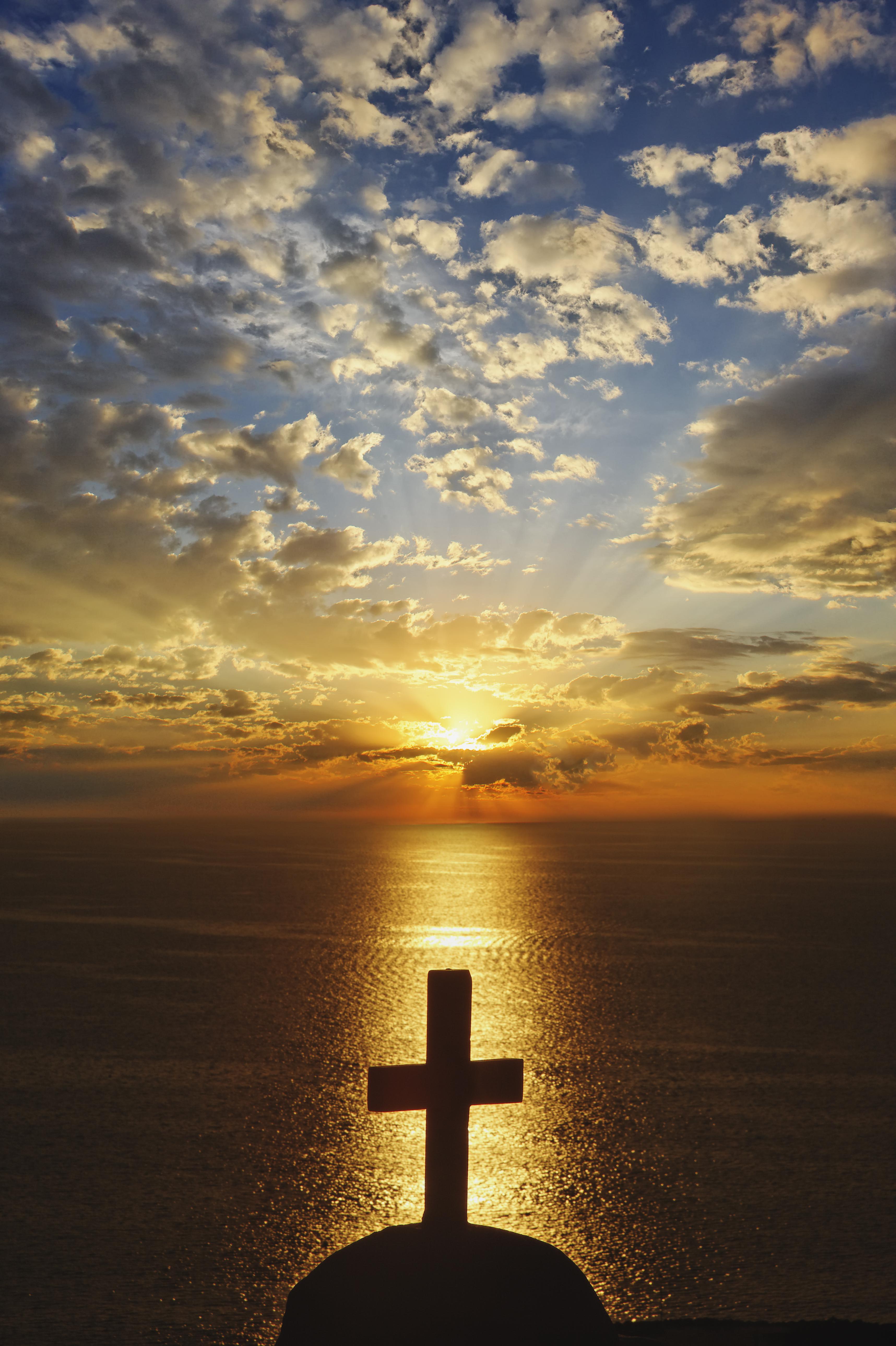 Church cross at sunset