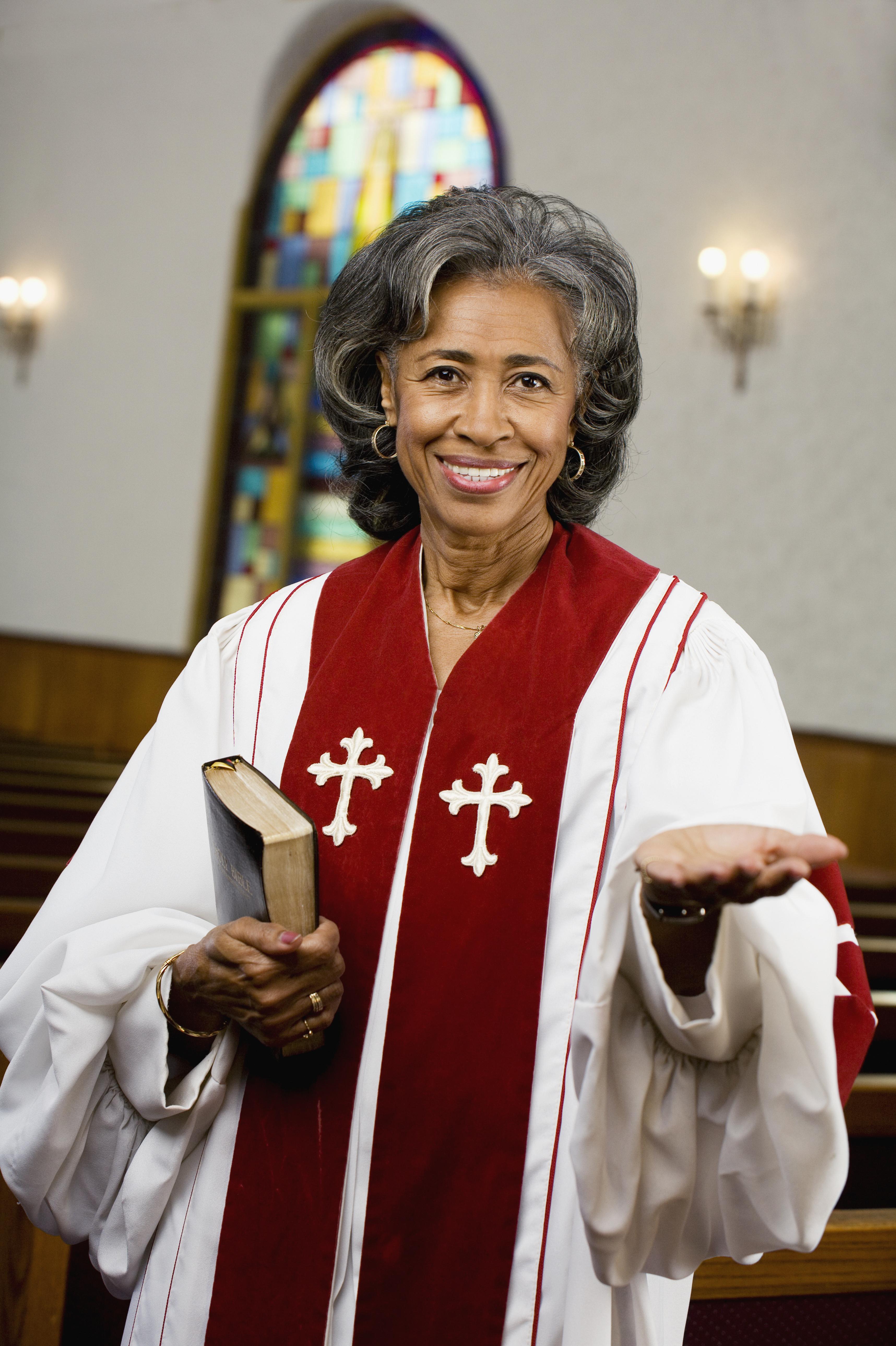 African American female Reverend holding Bible