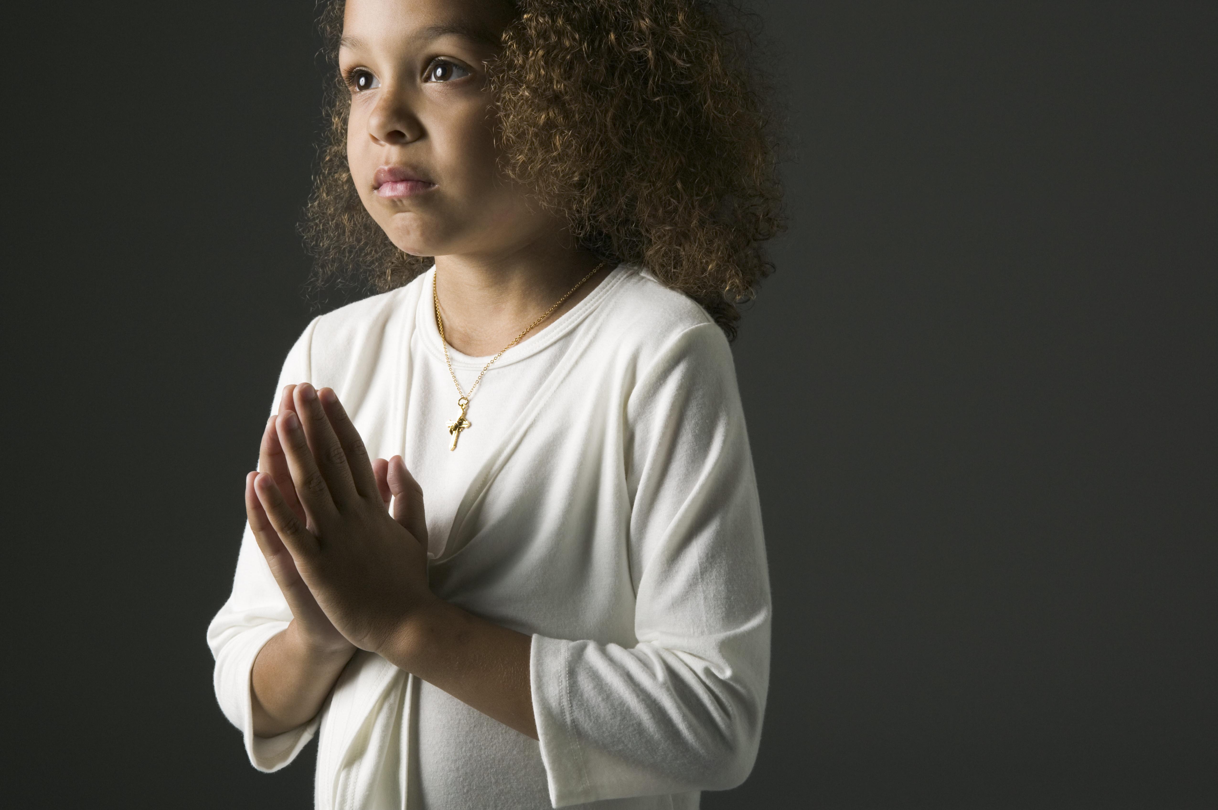Young African girl praying