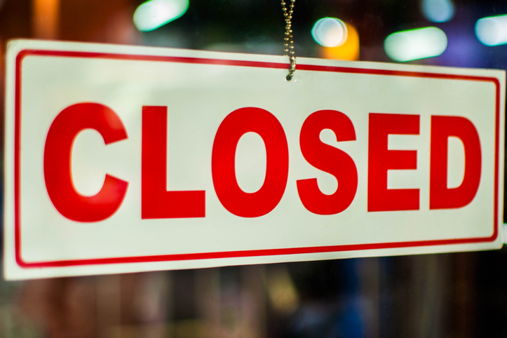 A glass door with "closed" store sign