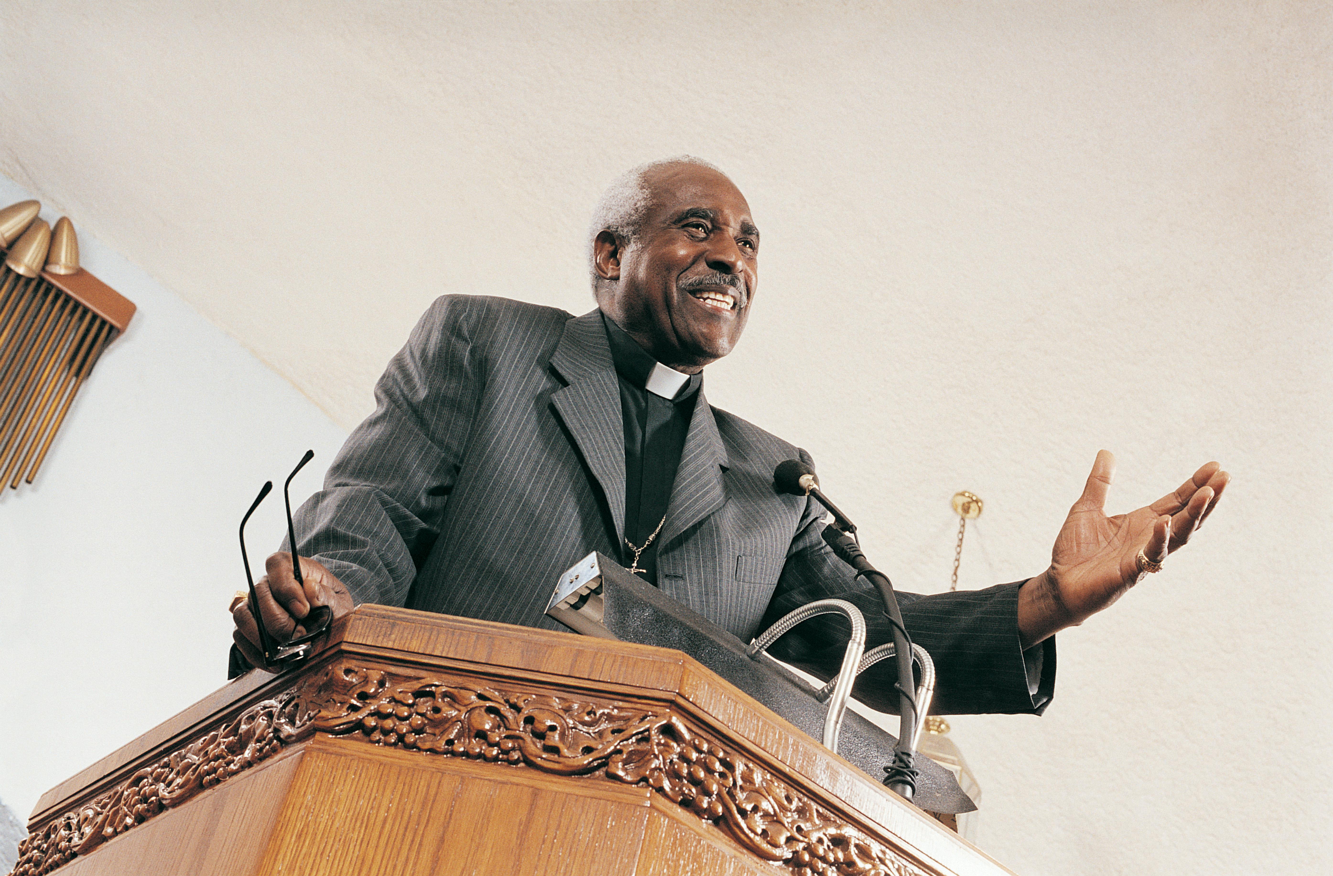 Low Angle View of a Priest Preaching From a Church Pulpit During a Service
