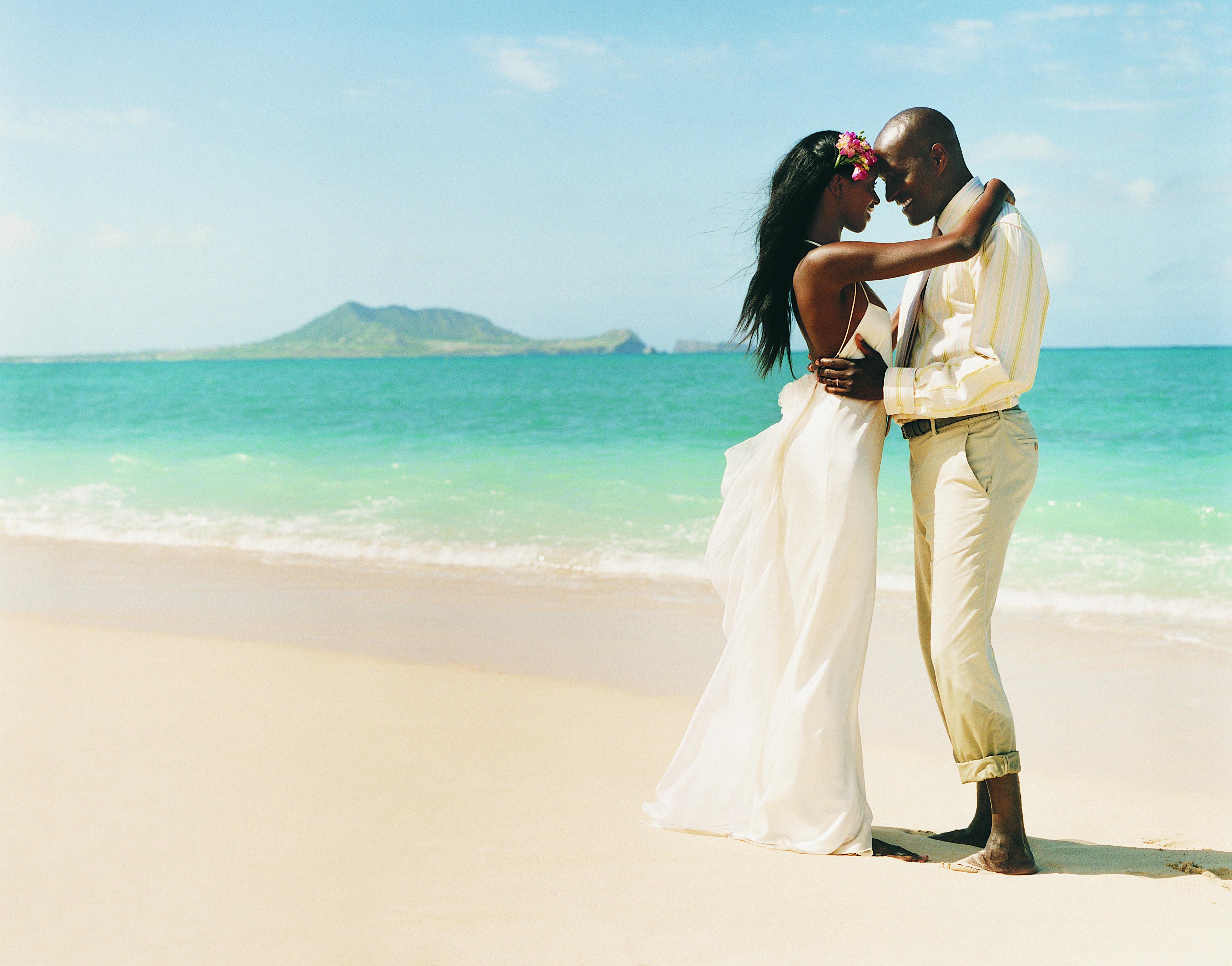 Newlywed Couple Dance Face-to-Face at the Waters Edge on a Beach